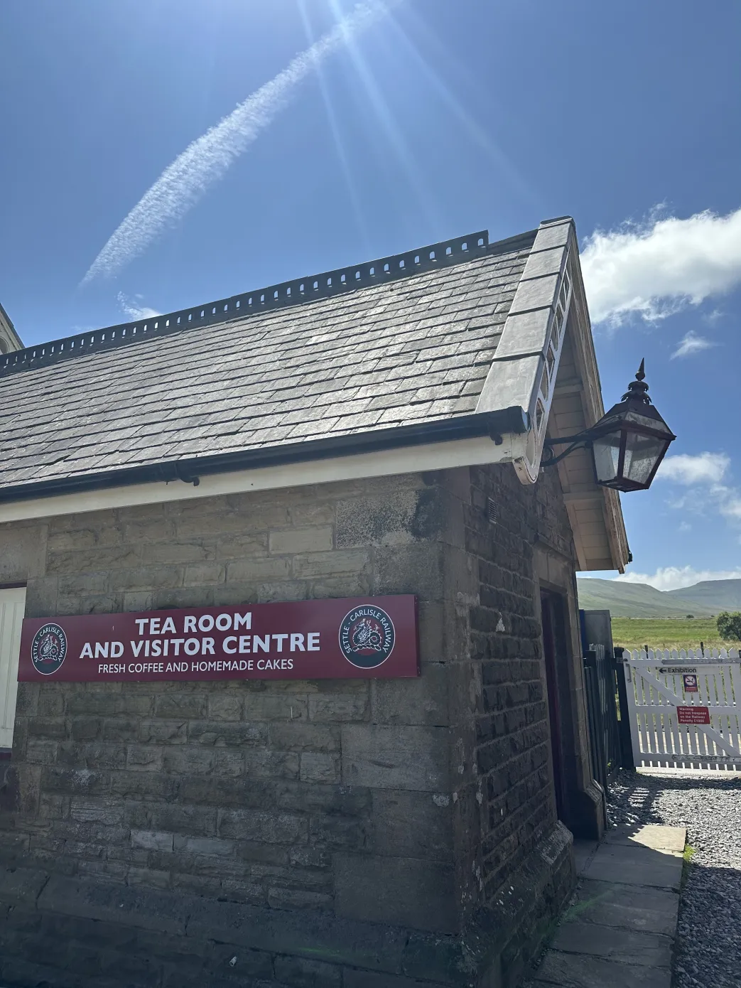Stone railway building with sign Tea Room and Visitor Centre