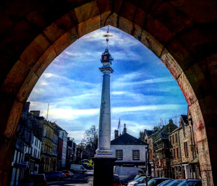 Archway looking up a street with monument