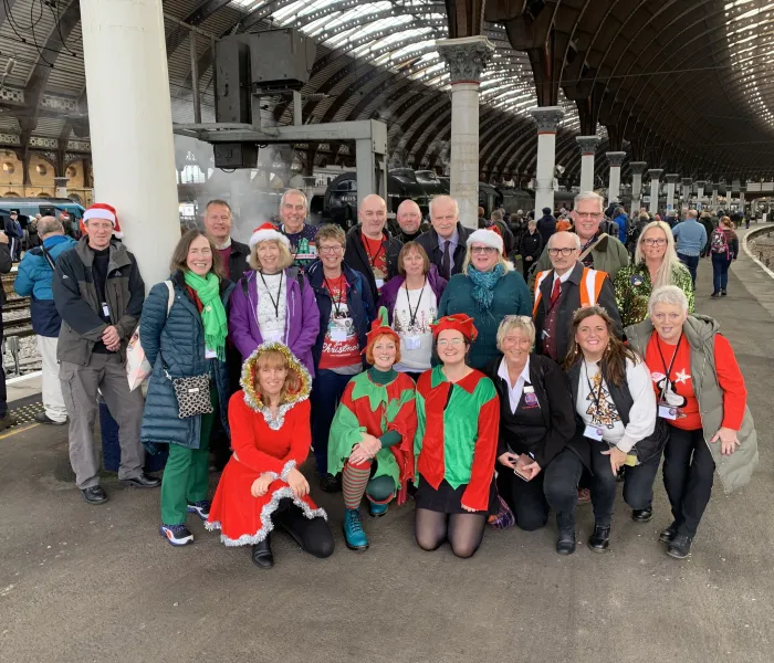 Group of people dressed in Christmas clothing on a platform