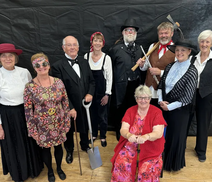 A group of people in costumes from the padt 150 years