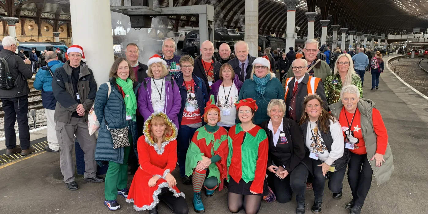 Group of people dressed in Christmas clothing on a platform