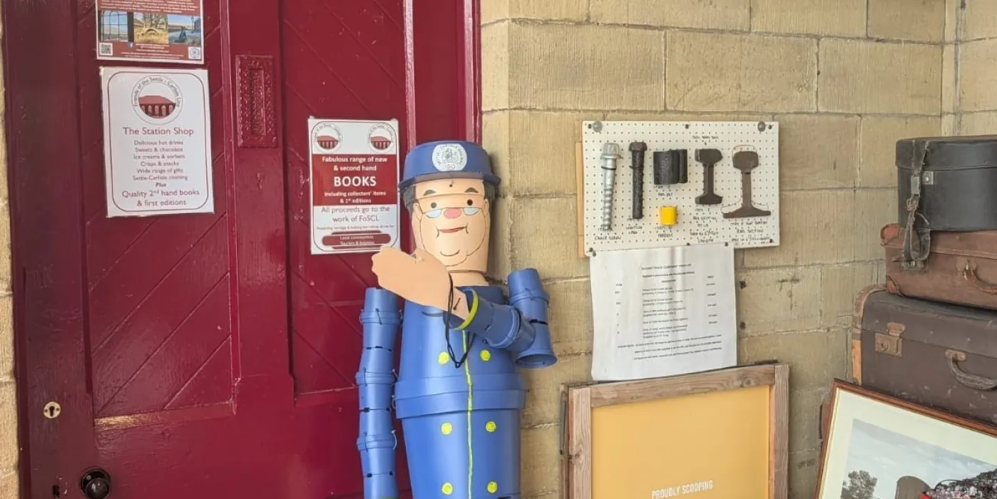 A Midland Station with a character  Northern Guard made out of plant pots,