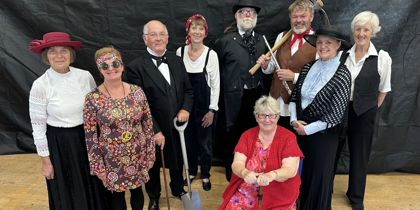 A group of people in costumes from the padt 150 years